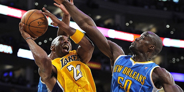April 26: Los Angeles Lakers guard Kobe Bryant, left, goes up for a shot as New Orleans Hornets center Emeka Okafor defends during the second half in Game 5 of a first-round NBA basketball playoff series in Los Angeles.