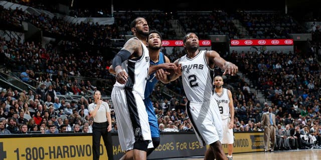 SAN ANTONIO, TX - DECEMBER 28: LaMarcus Aldridge #12 of the San Antonio Spurs and Kawhi Leonard #2 of the San Antonio Spurs box out against Karl-Anthony Towns #32 of the Minnesota Timberwolves on December 28, 2015 at the AT&T Center in San Antonio, Texas. NOTE TO USER: User expressly acknowledges and agrees that, by downloading and or using this photograph, user is consenting to the terms and conditions of the Getty Images License Agreement. Mandatory Copyright Notice: Copyright 2015 NBAE (Photos by Chris Covatta/NBAE via Getty Images)