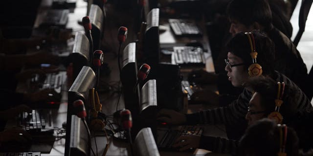 n this Jan. 25, 2010 file photo, people use computers at an Internet cafe in Taiyuan, in north China's Shanxi province. China is poised to pass a law requiring telecommunications and Internet companies to report any revelation of state secrets, potentially forcing businesses to collaborate with the country's vast security apparatus that stifles political dissent. The move to make communications companies monitor and inform on clients' activities, reported Tuesday, April 27, 2010, by state media, comes as China continues tightening controls on the Internet and telecommunications services.