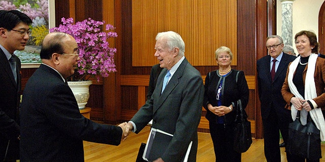 April 26: n this photo released by Korean Central News Agency via Korea News Service in Tokyo, former U.S. President Jimmy Carter, center, is greeted by Pak Ui Chun, second left, North Korea's foreign minister, in the Paekhwawon state guesthouse in Pyongyang, North Korea.