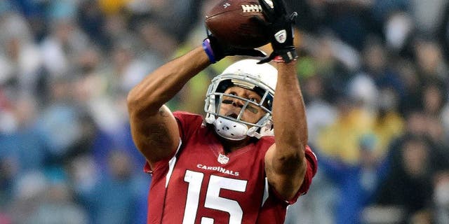 Jan 3, 2015; Charlotte, NC, USA; Arizona Cardinals wide receiver Michael Floyd (15) catches a pass over Carolina Panthers cornerback Josh Norman (24) during the first quarter in the 2014 NFC Wild Card playoff football game at Bank of America Stadium. Mandatory Credit: Bob Donnan-USA TODAY Sports