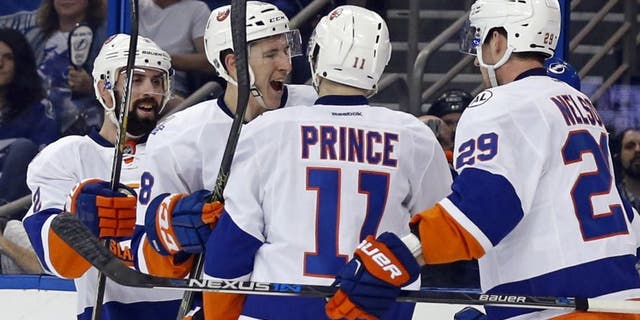 TAMPA, FL - APRIL 27: Shane Prince #11 of the New York Islanders is congratulated on his goal by teammates Nick Leddy #2, Ryan Strome #18 and Brock Nelson #29 against the Tampa Bay Lightning during the first period in Game One of the Eastern Conference Second Round during the 2016 NHL Stanley Cup Playoffs at Amalie Arena on April 27, 2016 in Tampa, Florida. (Photo by Mike Carlson/Getty Images)