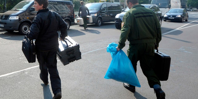April 29: German criminal officers leave a building in Dusseldorf, Germany, where two of three suspected members of the Al Qaeda terrorist organization were arrested.