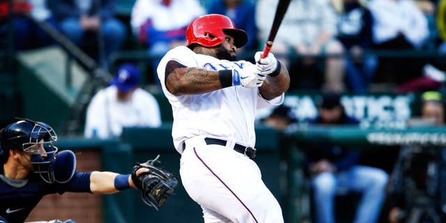 Apr 28, 2015; Arlington, TX, USA; Texas Rangers designated hitter Prince Fielder (84) follows through on his single against the Seattle Mariners during the first inning of a baseball game at Globe Life Park in Arlington. Mandatory Credit: Jim Cowsert-USA TODAY Sports