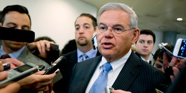FILE - In this April 14, 2015, file photo, Sen.  Robert Menendez, D-N.J. speaks with members of the media on Capitol Hill in Washington. Menendez, facing a federal indictment on bribery and corruption charges, reported his legal defense fund has raised nearly $1.3 million since it was launched last year and $430,000 from the start of this year until the day before he was indicted. Menendez, a Democrat, has denied any wrongdoing and vowed to fight the indictment, which alleges he helped his longtime friend and co-defendant, Florida eye doctor Salomon Melgen, with his business dealings in exchange for trips to a lavish villa in the Dominican Republic and campaign donations. (AP Photo/Manuel Balce Ceneta, File)