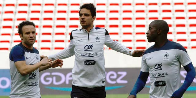 French soccer team midfielders Mathieu Valbuena, left, Clement Grenier, center, and Rio Mavuba, attends a training session, at the Allianz Riviera Stadium, in Nice, southeastern France, Saturday, May 31, 2014. France, which will face Paraguay on Sunday, is preparing for the upcoming soccer World Cup in Brazil starting on 12 June. (AP Photo/Claude Paris)