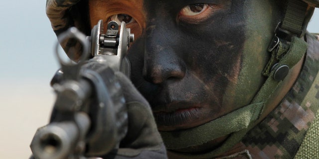 A South Korean Marine takes position during the joint military exercises between South Korea and the United States.
