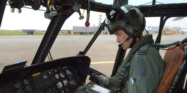 This image released by the British Ministry of Defense on Friday Sept. 17, 2010 shows Prince William at the controls of his Sea King helicopter in Bangor, Wales.