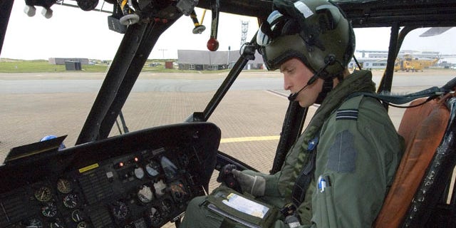 This image released by the British Ministry of Defense on Friday Sept. 17, 2010 shows Prince William at the controls of his Sea King helicopter in Bangor, Wales.