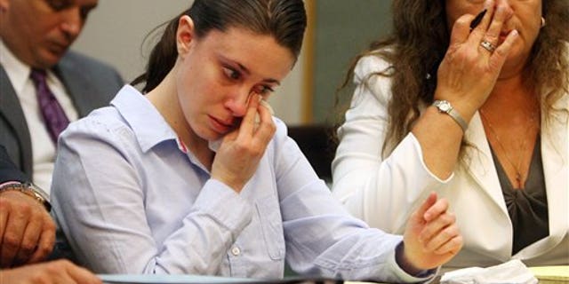 Aug. 21, 2009: Casey Anthony wipes tears from her eyes after seeing her father George Anthony testify during a court hearing in Orlando, Fla.