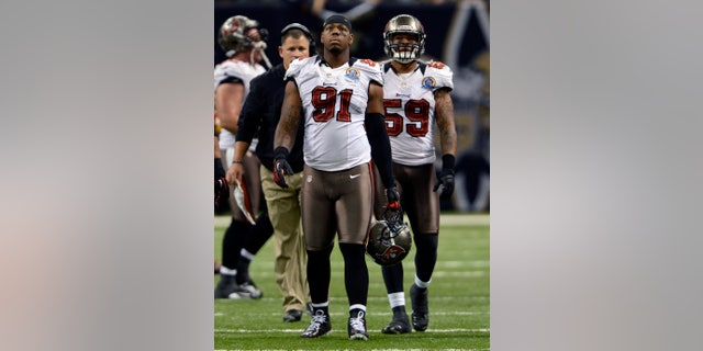 FILE - In this Dec. 16, 2012, file photo, Tampa Bay Buccaneers defensive end Da'Quan Bowers (91) walks off the field during an NFL football game in New Orleans. Bowers was arrested at LaGuardia Airport in New York on Monday, Feb. 18, 2013, after police found a loaded handgun in his luggage, according to authorities. (AP Photo/Bill Feig, File)