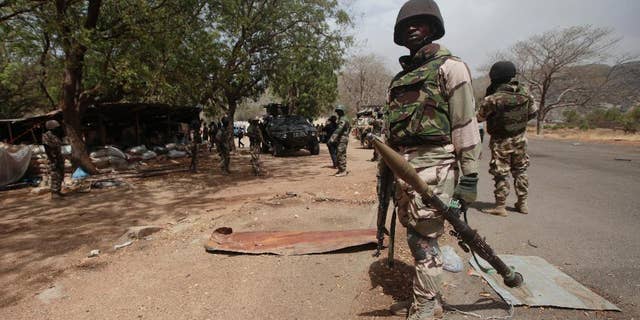 FILE - Nigerian soldiers man a checkpoint in Gwoza, Nigeria, a town liberated from Boko Haram, April 8, 2015.