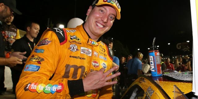 KANSAS CITY, KS - MAY 07: Kyle Busch, driver of the #18 M&amp;M's Red Nose Toyota, celebrates after winning the NASCAR Sprint Cup Series Go Bowling 400 at Kansas Speedway on May 7, 2016 in Kansas City, Kansas. (Photo by Sean Gardner/NASCAR via Getty Images)
