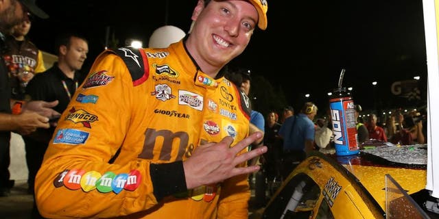 KANSAS CITY, KS - MAY 07: Kyle Busch, driver of the #18 M&M's Red Nose Toyota, celebrates after winning the NASCAR Sprint Cup Series Go Bowling 400 at Kansas Speedway on May 7, 2016 in Kansas City, Kansas. (Photo by Sean Gardner/NASCAR via Getty Images)