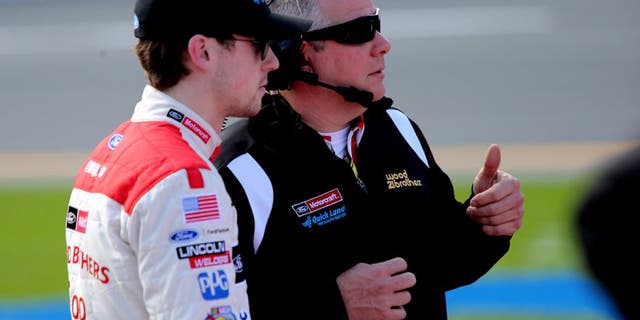 DAYTONA BEACH, FL - FEBRUARY 14: Ryan Blaney, driver of the #21 Motorcraft/Quick Lane Tire & Auto Center Ford, talks with crew chief Jeremy Bullins on the grid during qualifying for the NASCAR Sprint Cup Series Daytona 500 at Daytona International Speedway on February 14, 2016 in Daytona Beach, Florida. (Photo by Jerry Markland/Getty Images)