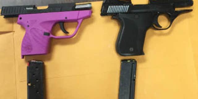 April 30, 2015: In this photo provided by Kentucky State Police, handguns sit on a table.