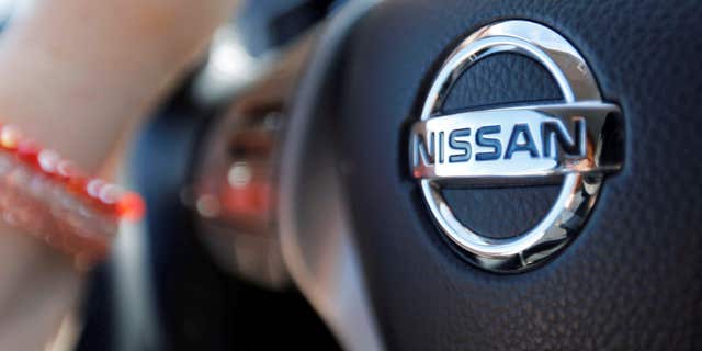 April 23, 2016: A logo of Nissan Motor Co is seen on a steering wheel as a woman drives her car in Golfech, southwestern France.