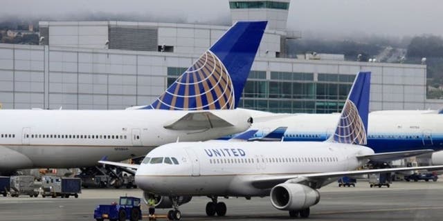 At least five people suffered minor injuries Tuesday night after a United Airlines plane engine caught fire at Newark Liberty International Airport, officials said.