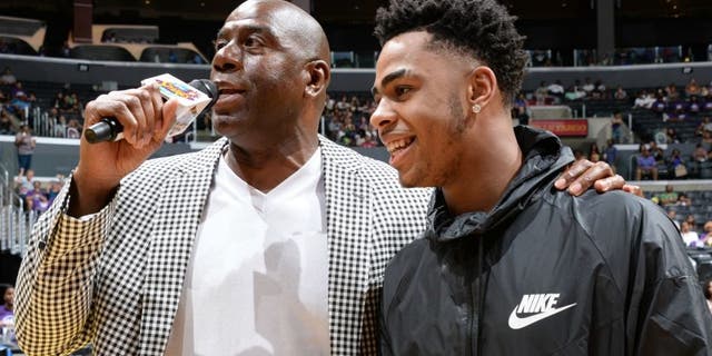 LOS ANGELES, CA - AUGUST 30: Los Angeles Sparks Owner Magic Johnson interviews D'Angelo Russell #1 of the Los Angeles Lakers during a game between the Los Angeles Sparks and the San Antonio Stars at STAPLES Center on August 30, 2015 in Los Angeles, California. NOTE TO USER: User expressly acknowledges and agrees that, by downloading and/or using this Photograph, user is consenting to the terms and conditions of the Getty Images License Agreement. Mandatory Copyright Notice: Copyright 2015 NBAE (Photo by Andrew D. Bernstein/NBAE via Getty Images)