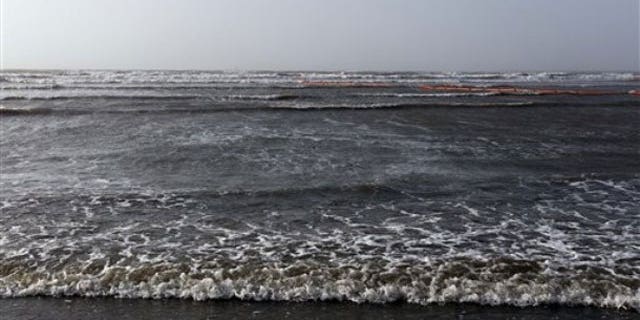 May 2: Water from the Gulf of Mexico washes ashore on an island near the South Pass of the Mississippi River near Venice, La. (AP).