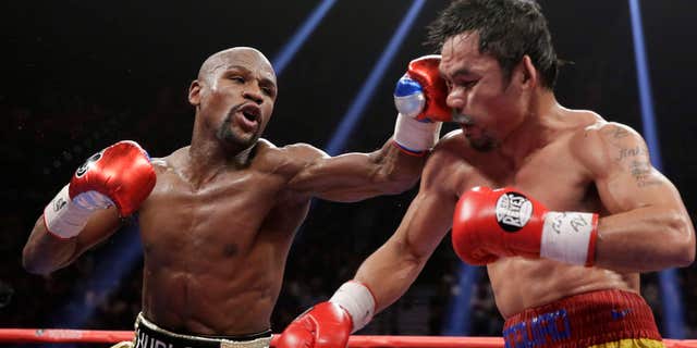 May 2, 2015: Floyd Mayweather Jr., left, hits Manny Pacquiao, from the Philippines, during their welterweight title fight.