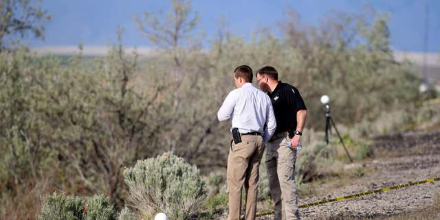 April 30, 2015: Officers with the Department of Public Safety State Bureau of Investigation process the scene where human remains inside a suitcase were discovered on the side of I-80 near Saltair in Magna, Utah.