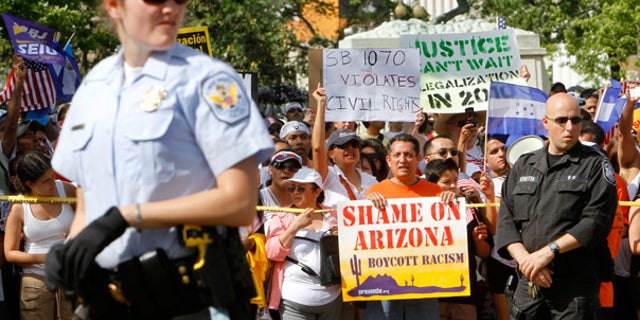May 1: Protesters hold signs against Arizona's tough new immigration law, near the White House.