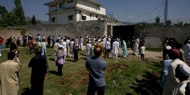 May 3: Local people and media gather outside the perimeter wall and sealed gate into the compound and a house where Al Qaeda leader Usama bin Laden was caught and killed late Monday, in Abbottabad, Pakistan.