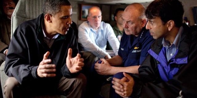 FILE: President Obama talks with U.S. Coast Guard Commandant Adm. Thad Allen and Louisiana Gov. Bobby Jindal aboard Marine One on May 2 as they fly along the coastline from Venice, La.