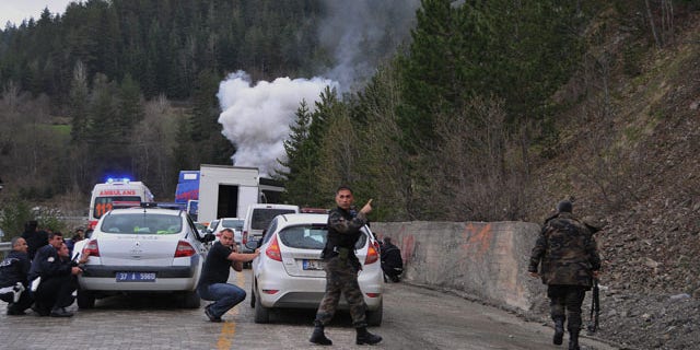 May 4: Security force members seen just after suspected Kurdish rebels killed one policeman and wounded another in an armed attack on a police vehicle following an election rally by Turkey's Prime Minister Recep Tayyip Erdogan in Kastamonu province in central Turkey.