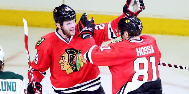 May 4, 2014; Chicago, IL, USA; Chicago Blackhawks left wing Bryan Bickell (29) celebrates with right wing Marian Hossa (81) after scoring a goal against the Minnesota Wild during the third period in game two of the second round of the 2014 Stanley Cup Playoffs at United Center. Mandatory Credit: Jerry Lai-USA TODAY Sports