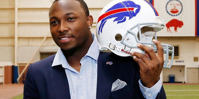 Mar 10, 2015; Orchard Park, NY, USA; Buffalo Bills running back LeSean McCoy poses with a Bills helmet in the AD Pro training facility after a press conference at Ralph Wilson Stadium. Mandatory Credit: Kevin Hoffman-USA TODAY Sports