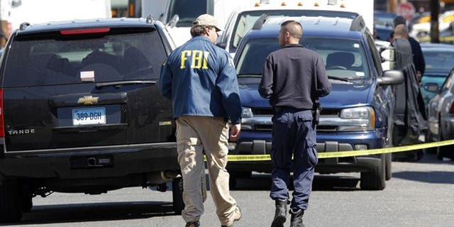 May 4: FBI personnel walk down the street of Pakistani-American Faisal Shahzad on Sheridan Street in Bridgeport, Connecticut.