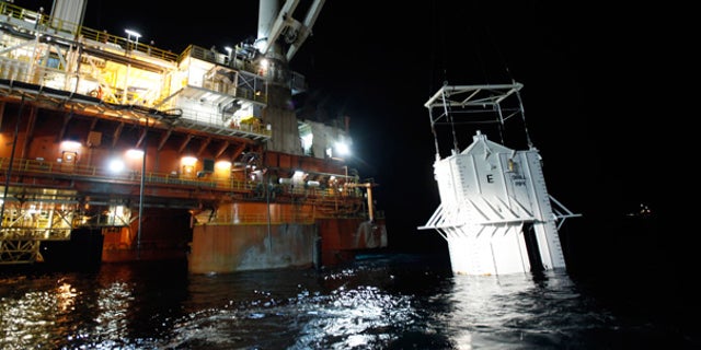 May 6: The oil containment box is lowered into the Gulf at the site of the Deepwater Horizon rig collapse.