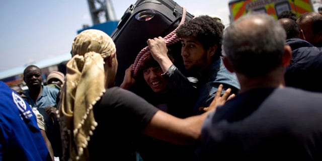 May 4: A Libyan man, center, tries to leave from the besieged city of Misrata, Libya.