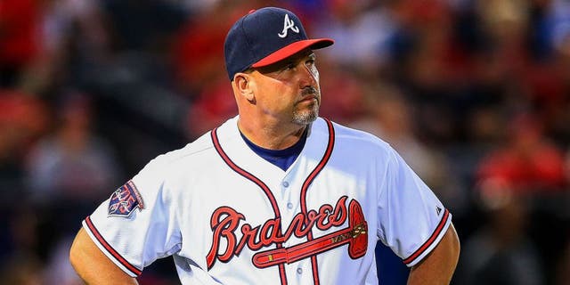 May 5, 2014; Atlanta, GA, USA; Atlanta Braves manager Fredi Gonzalez (33) waits on the field during a replay challenge in the sixth inning against the St. Louis Cardinals at Turner Field. Mandatory Credit: Daniel Shirey-USA TODAY Sports