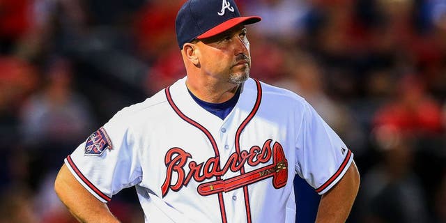 May 5, 2014; Atlanta, GA, USA; Atlanta Braves manager Fredi Gonzalez (33) waits on the field during a replay challenge in the sixth inning against the St. Louis Cardinals at Turner Field. Mandatory Credit: Daniel Shirey-USA TODAY Sports
