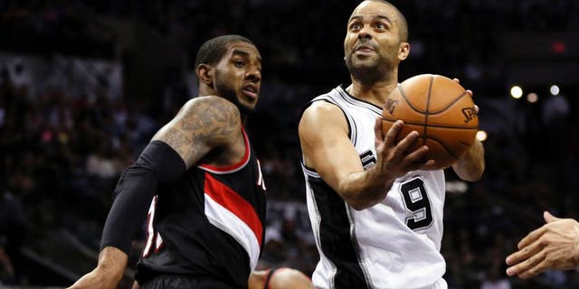 May 6, 2014; San Antonio, TX, USA; San Antonio Spurs guard Tony Parker (9) drives to the basket past Portland Trail Blazers forward LaMarcus Aldridge (12) in game one of the second round of the 2014 NBA Playoffs at AT&T Center. Mandatory Credit: Soobum Im-USA TODAY Sports