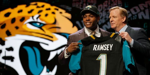 CHICAGO, IL - APRIL 28: (L-R) Jalen Ramsey of the Florida State Seminoles holds up a jersey with NFL Commissioner Roger Goodell after being picked #5 overall by the Jacksonville Jaguarsduring the first round of the 2016 NFL Draft at the Auditorium Theatre of Roosevelt University on April 28, 2016 in Chicago, Illinois. (Photo by Jon Durr/Getty Images)