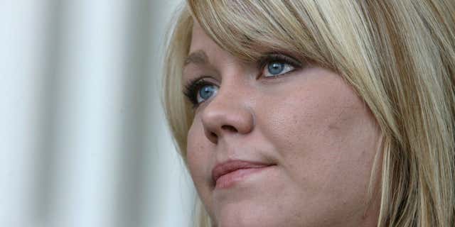 July 27, 2010: Elissa Wall talks with reporters at the Matheson courthouse in Salt Lake City, about the Utah Supreme Court ordering a new trial for polygamous leader Warren Jeffs.