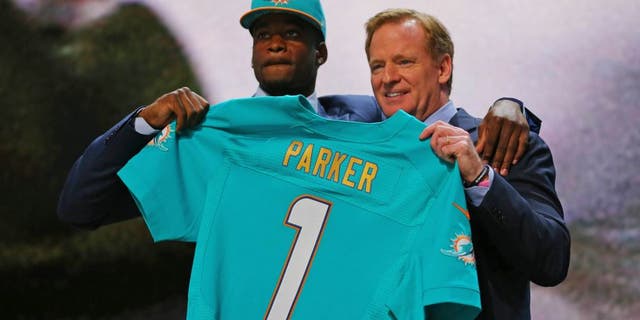 Apr 30, 2015; Chicago, IL, USA; DeVante Parker (Louisville) poses for a photo with NFL commissioner Roger Goodell after being selected as the number 14th overall pick to the Miami Dolphins in the first round of the 2015 NFL Draft at the Auditorium Theatre of Roosevelt University. Mandatory Credit: Dennis Wierzbicki-USA TODAY Sports