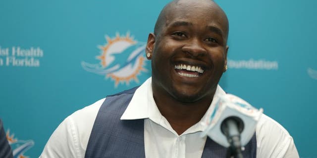 FILE - In this April 29, 2016, file photo, top Miami Dolphins draft pick Laremy Tunsil smiles during a news conference, in Davie, Fla. Tunsil and the Dolphins were quick to agree on his value in the wake of his NFL draft freefall. The offensive lineman from Ole Miss signed his rookie contract before joining the Dolphins' rookie minicamp which began Friday, May 6, 2016. (AP Photo/Lynne Sladky)