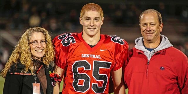 Timothy Piazza, center, with his parents Evelyn Piazza, left, and James Piazza, right, at Hunterdon Central Regional High School in 2014.