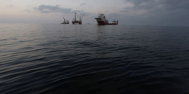 May 7: The Q4000, center, which has lowered the oil containment vessel to the sea floor, is seen at sunset from the offshore supply vessel Joe Griffin, at the site of the Deepwater Horizon oil spill containment efforts in the Gulf of Mexico off the coast of Lousiana.