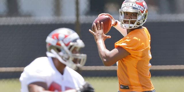 Tampa Bay Buccaneers quarterback Jameis Winston, rear, prepares to pass to tight end Emmanuel Ogbuehi as they run through drills during an NFL rookie minicamp in Tampa, Fla., Friday, May 8, 2015. (AP Photo/Wilfredo Lee)