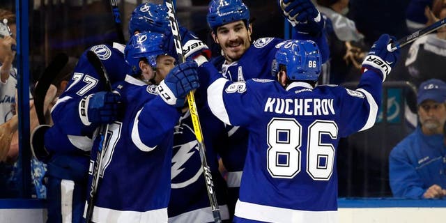 May 8, 2016; Tampa, FL, USA; Tampa Bay Lightning defenseman Victor Hedman (77) is congratulated by right wing Nikita Kucherov (86) and teammates after scored a goal against the New York Islanders during the second period in game five of the second round of the 2016 Stanley Cup Playoffs at Amalie Arena. Mandatory Credit: Kim Klement-USA TODAY Sports