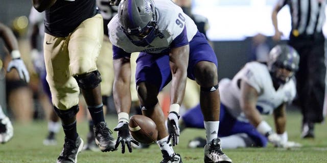 Sep 7, 2013; Boulder, CO, USA; Colorado Buffaloes offensive linesman Stephane Nembot (77) watches as Central Arkansas Bears defensive end Jonathan Woodard (90) chases down a fumble made by quarterback Connor Wood (not pictured) in the third quarter at Folsom Field. The Buffaloes defeated the Bears 38-24. Mandatory Credit: Ron Chenoy-USA TODAY Sports