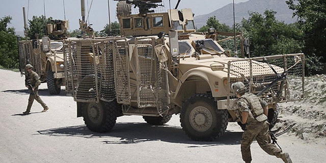 May 9: U.S. soldiers with the NATO led International Security Assistance Force (ISAF) react after their convoy was attacked by a suicide attacker using a motorcycle in Qarghayi, Laghman province east of Kabul, Afghanistan.