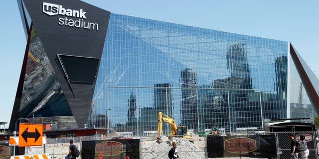 The Minneapolis skyline is reflected in the new U.S. Bank Stadium in Minneapolis as it nears completion for the $1.2 billion home of the Minnesota Vikings NFL football team beginning this season in Minneapolis. (AP Photo/Jim Mone)
