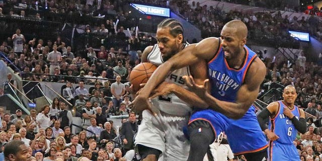 SAN ANTONIO, TX - MAY 10: Kawhi Leonard #2 of the San Antonio Spurs steals the ball away from Serge Ibaka #9 of the Oklahoma City Thunder in game Five of the Western Conference Semifinals during the 2016 NBA Playoffs at AT&T Center on May 10, 2016 in San Antonio, Texas. NOTE TO USER: User expressly acknowledges and agrees that , by downloading and or using this photograph, User is consenting to the terms and conditions of the Getty Images License Agreement. (Photo by Ronald Cortes/Getty Images)